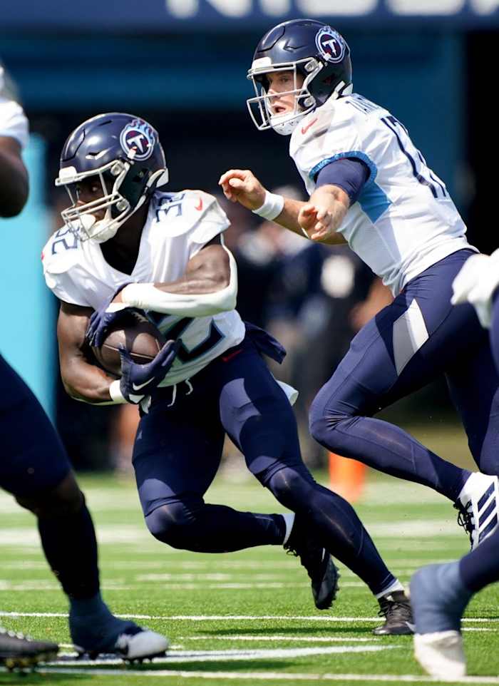 Tennessee Titans quarterback Ryan Tannehill (17) hands the ball off to running back Tyjae Spears (32) against the Los Angeles Chargers at Nissan Stadium.